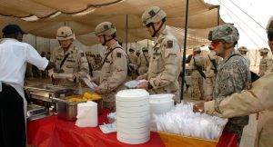 Soldiers file through the line at their Christmas cookout, Iraq 2005. 